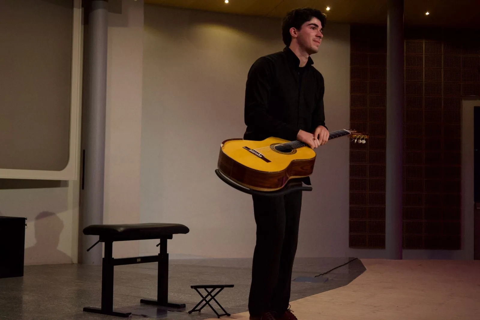 Miguel Ferreira standing on stage, guitar in hand.